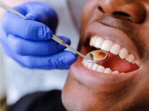Dentist examining a relaxed patient under mild dental sedation, demonstrating stress-free dental care at Ridgetop Dental.