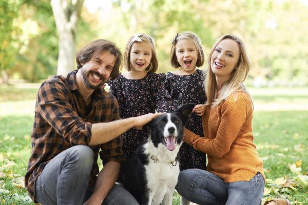 Portrait of smiling family and dog